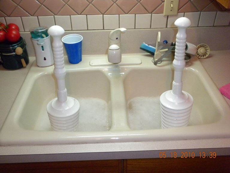 Soapy kitchen sink with plungers